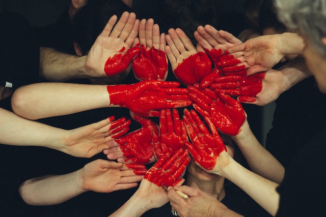 Hands together in solidarity painted with heart