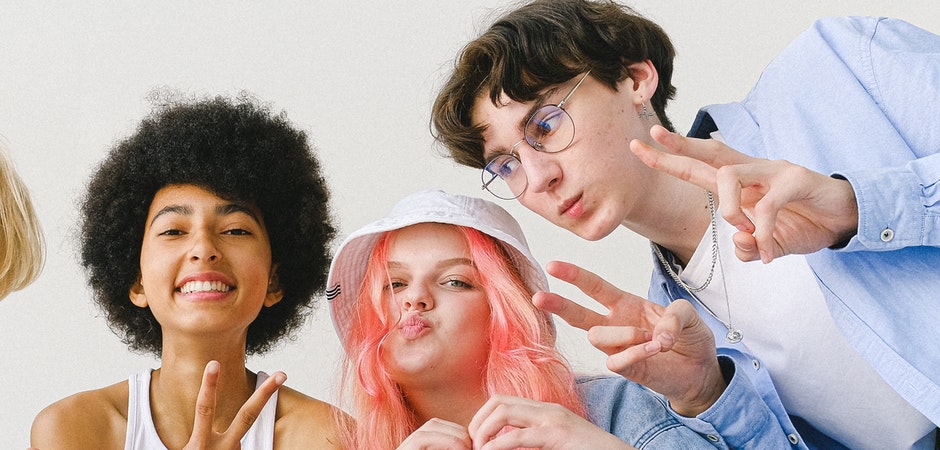 people smiling and making peace signs