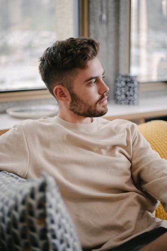 man looking out window